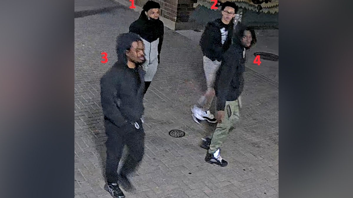 four persons of interest walking