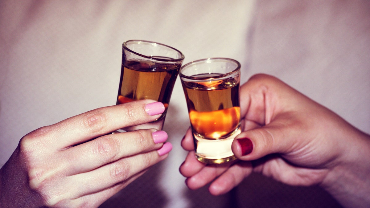 Two hands toasting whiskey on the rock, with isolated background
