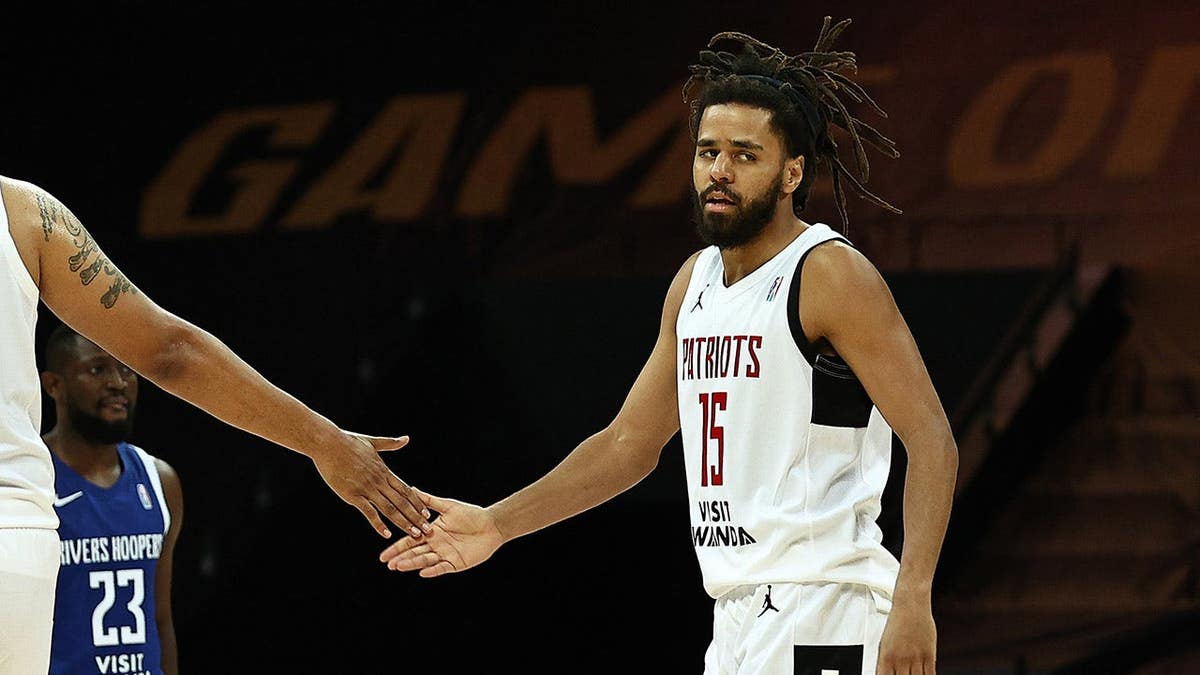 Jermaine Cole high-fiving teammate Brandon Costner during basketball game at Kigali Arena