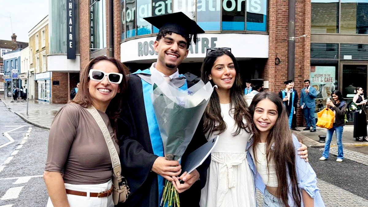 Khaled Sharif and his family smiling at Khaled's graduation.