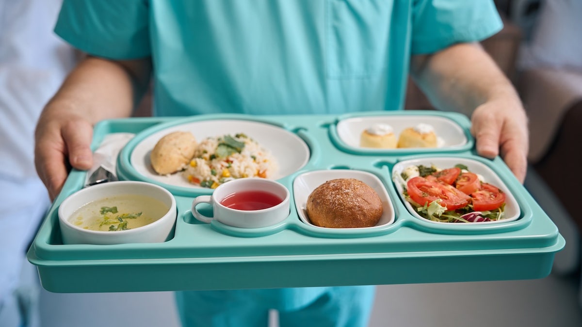 Nurse serving hospital food