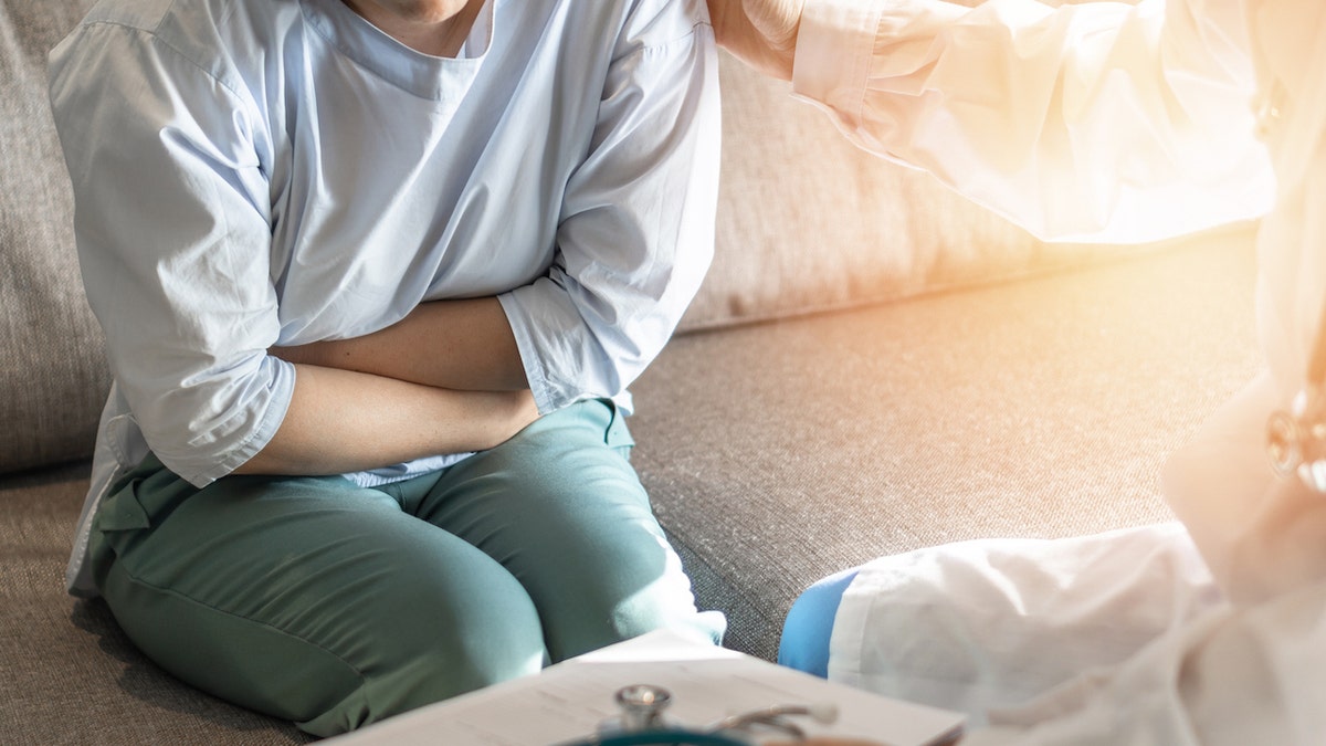 Woman undergoing medical exam with doctor in clinical setting