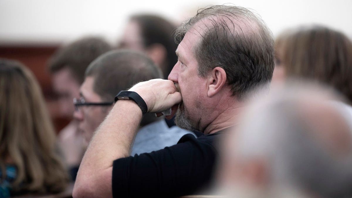 Tim Jones Sr. listening to defense attorney Casey Secor delivering closing arguments in courtroom.