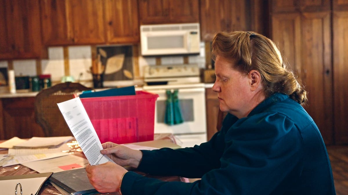 Julia Johnson standing in a scene from Trust Me: The False Prophet Season 1
