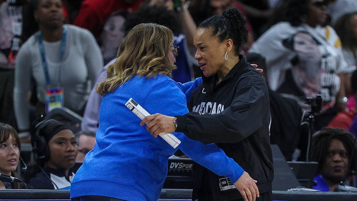 UCLA Bruins head coach Cori Close shaking hands with South Carolina Gamecocks head coach Dawn Staley on basketball court
