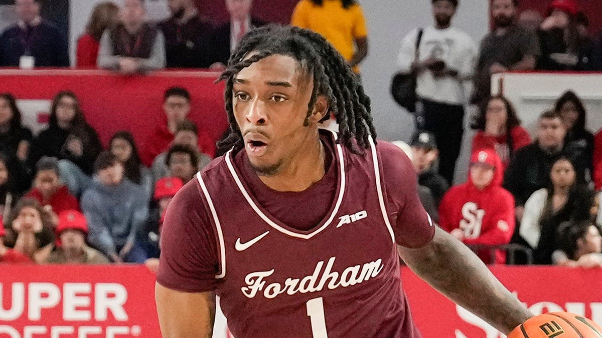 Will Richardson dribbling a basketball on court at Carnesecca Arena
