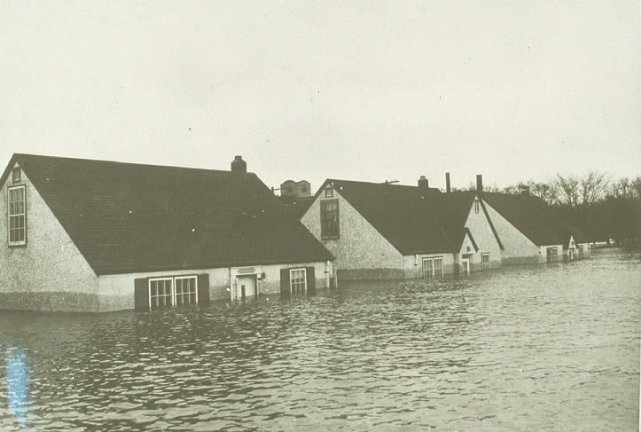 View of flooded homes in 1950. The black and white image shows water up to nearly the rooftops. 
