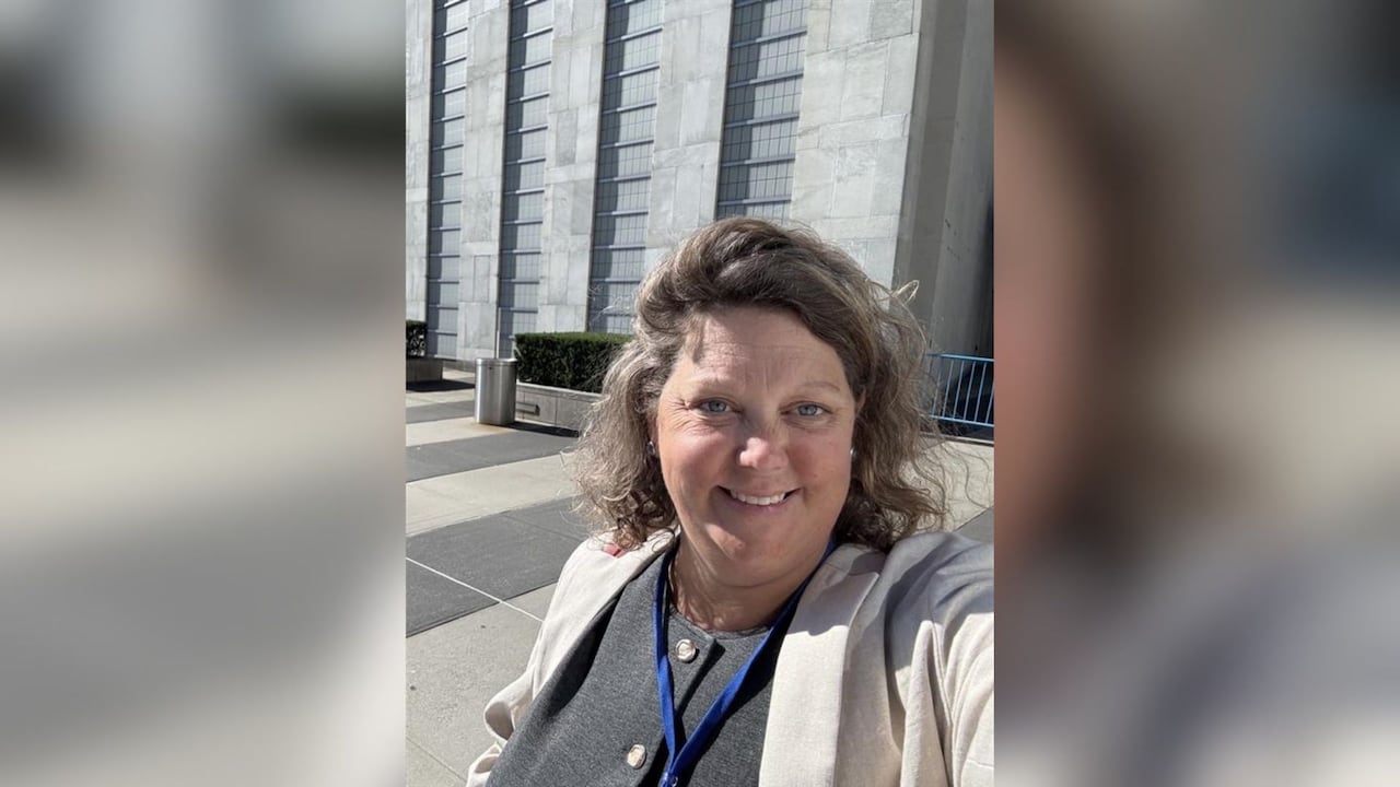 A woman taking a selfie. She has brown hair.