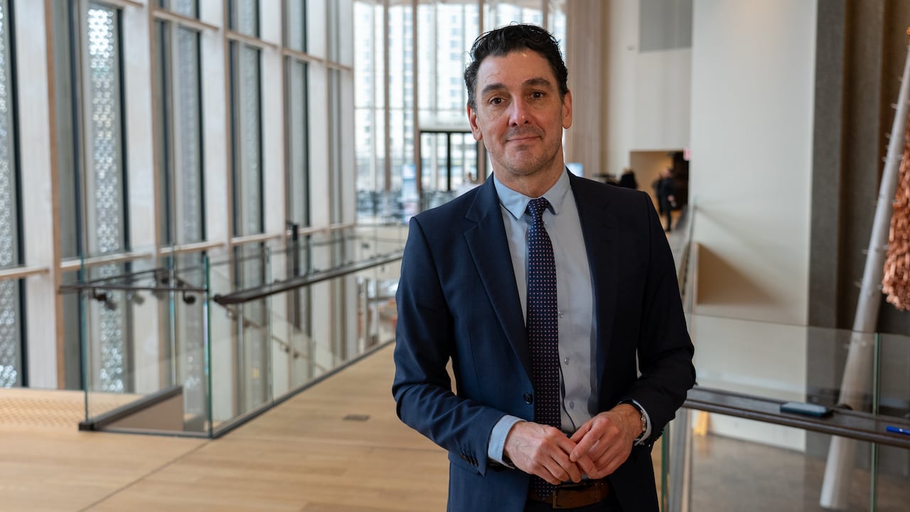 A man in a suit at a conference.