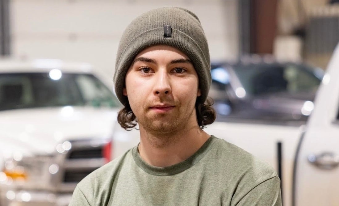 A man in a toque and a green shirt.