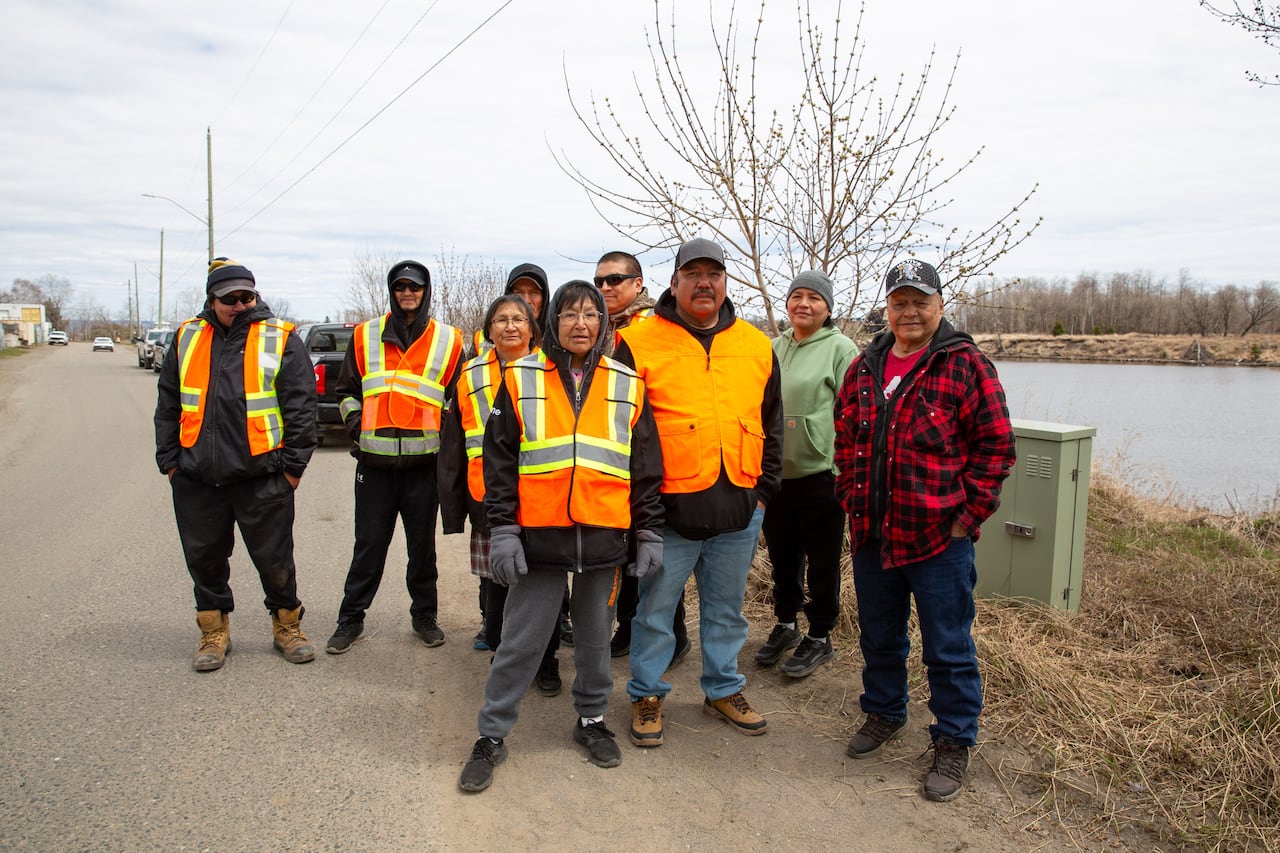 A group of people seen wearing high-vis vests outside by the water.