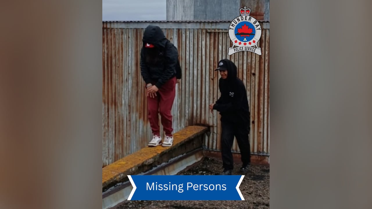 Two people are seen at an industrial site.