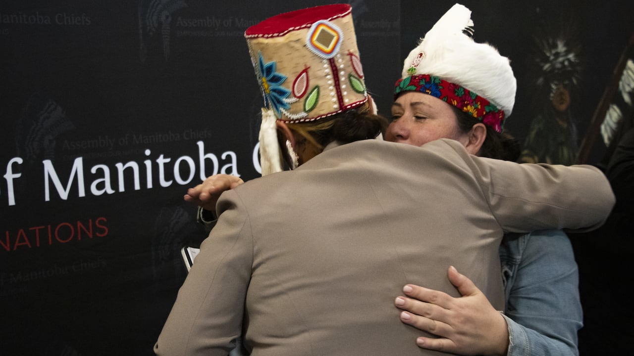 Two individuals embrace after historic court decision.