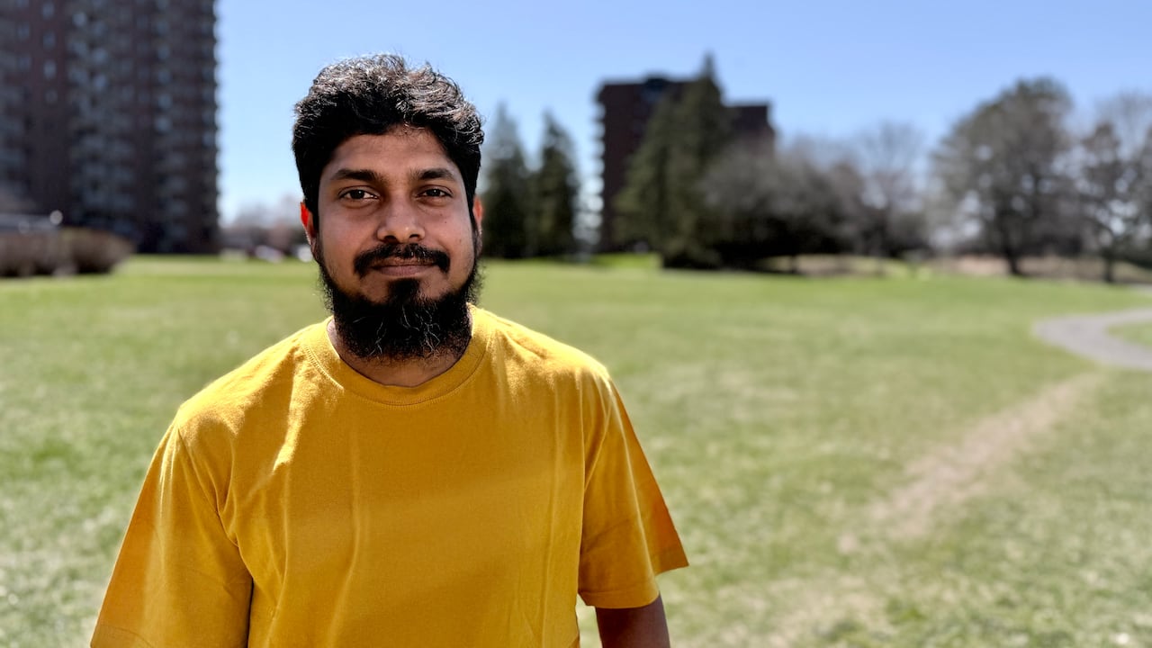 A man in a yellow shirt.