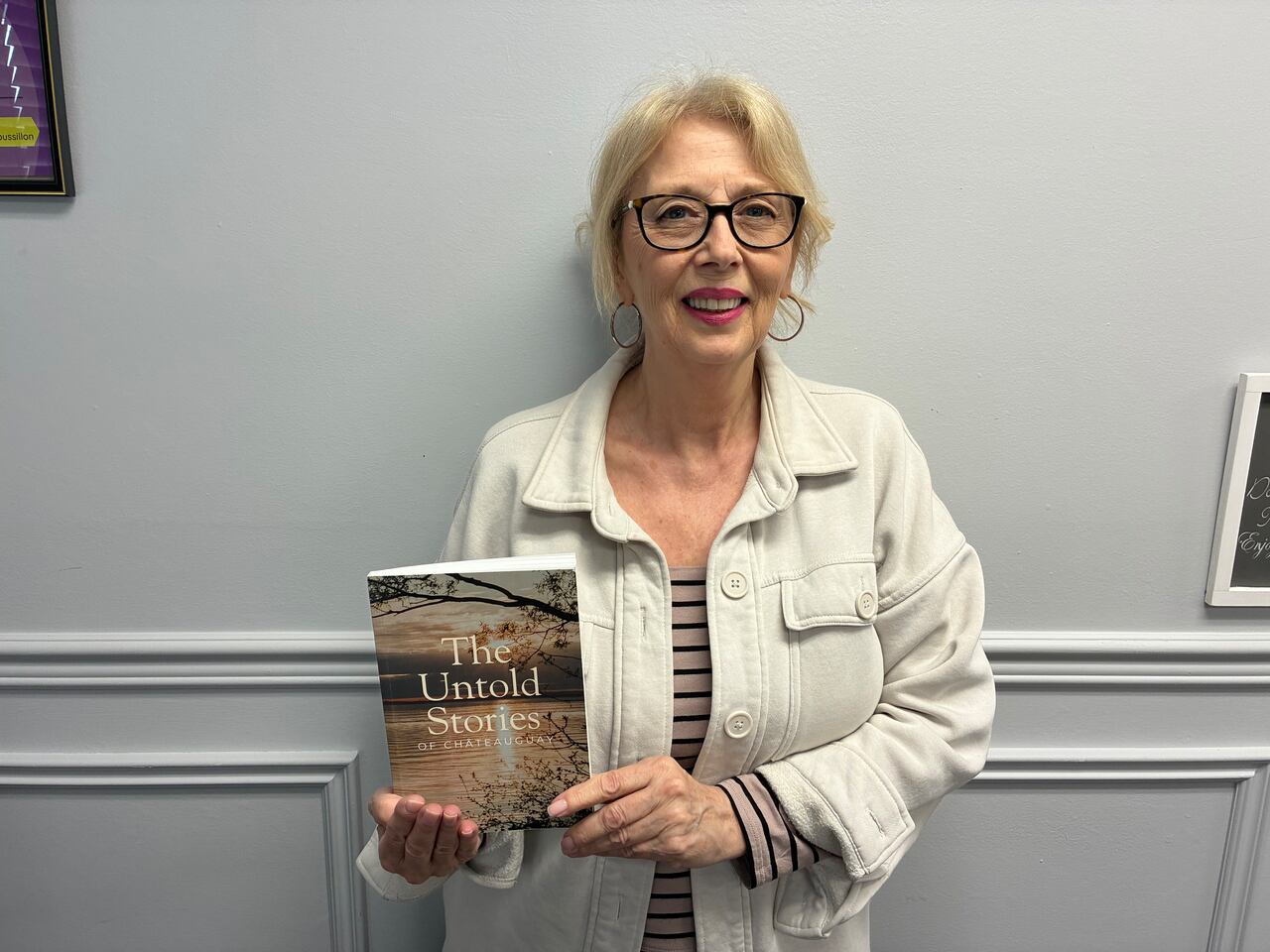 Françoise Goulet holds up the book, untold stories of Chateauguay