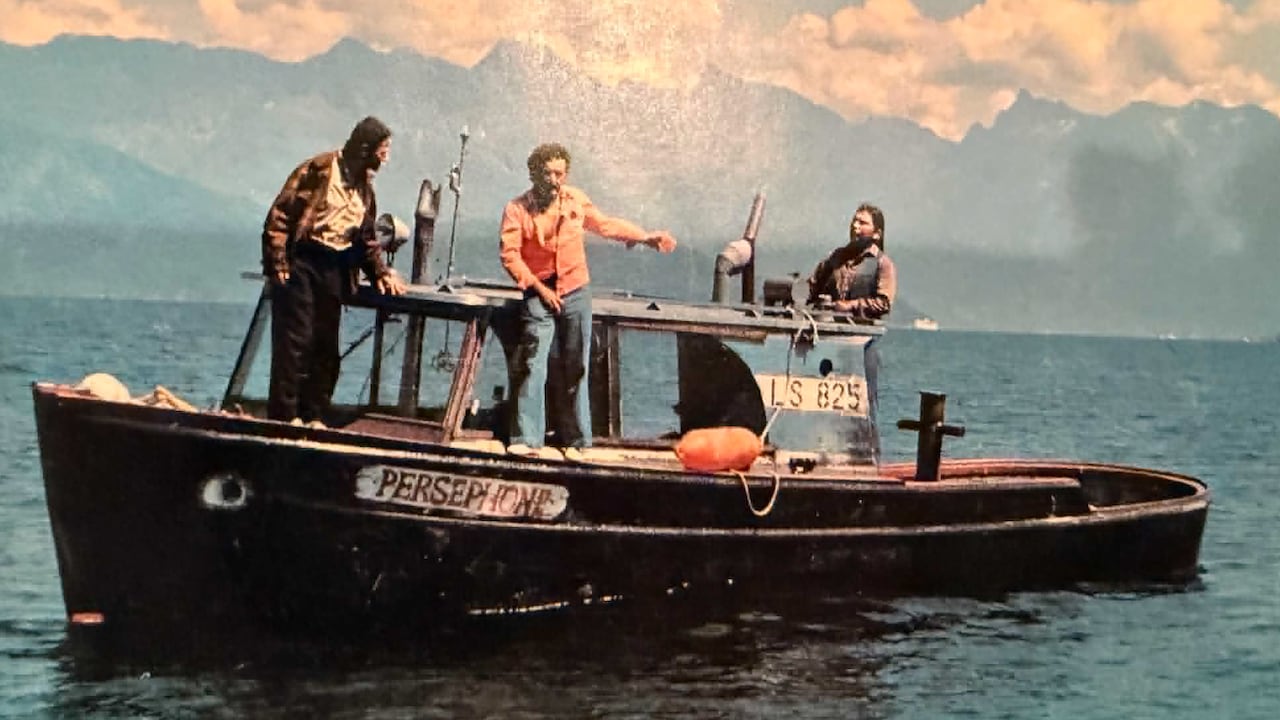 Three men standing on a boat