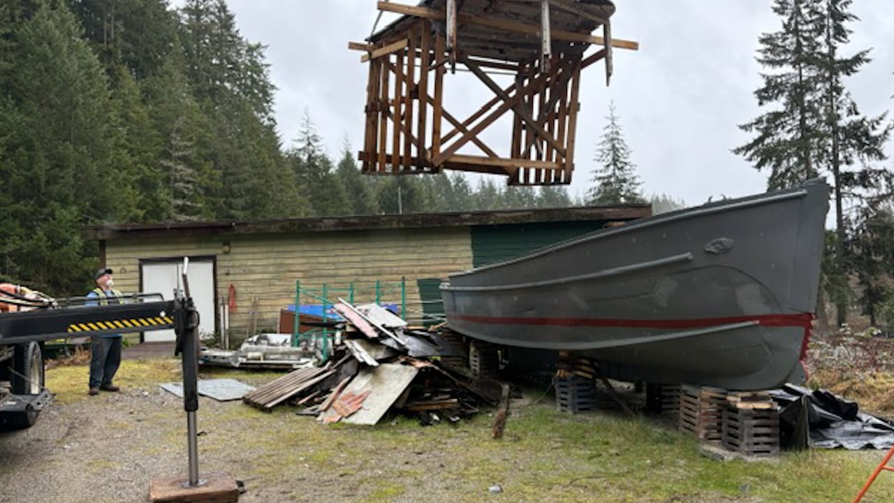 A section of the boat is lowered down onto the boat during the restoration.