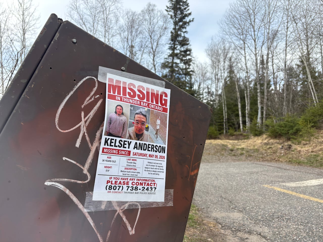 A missing persons poster is seen on a waste disposal bin.