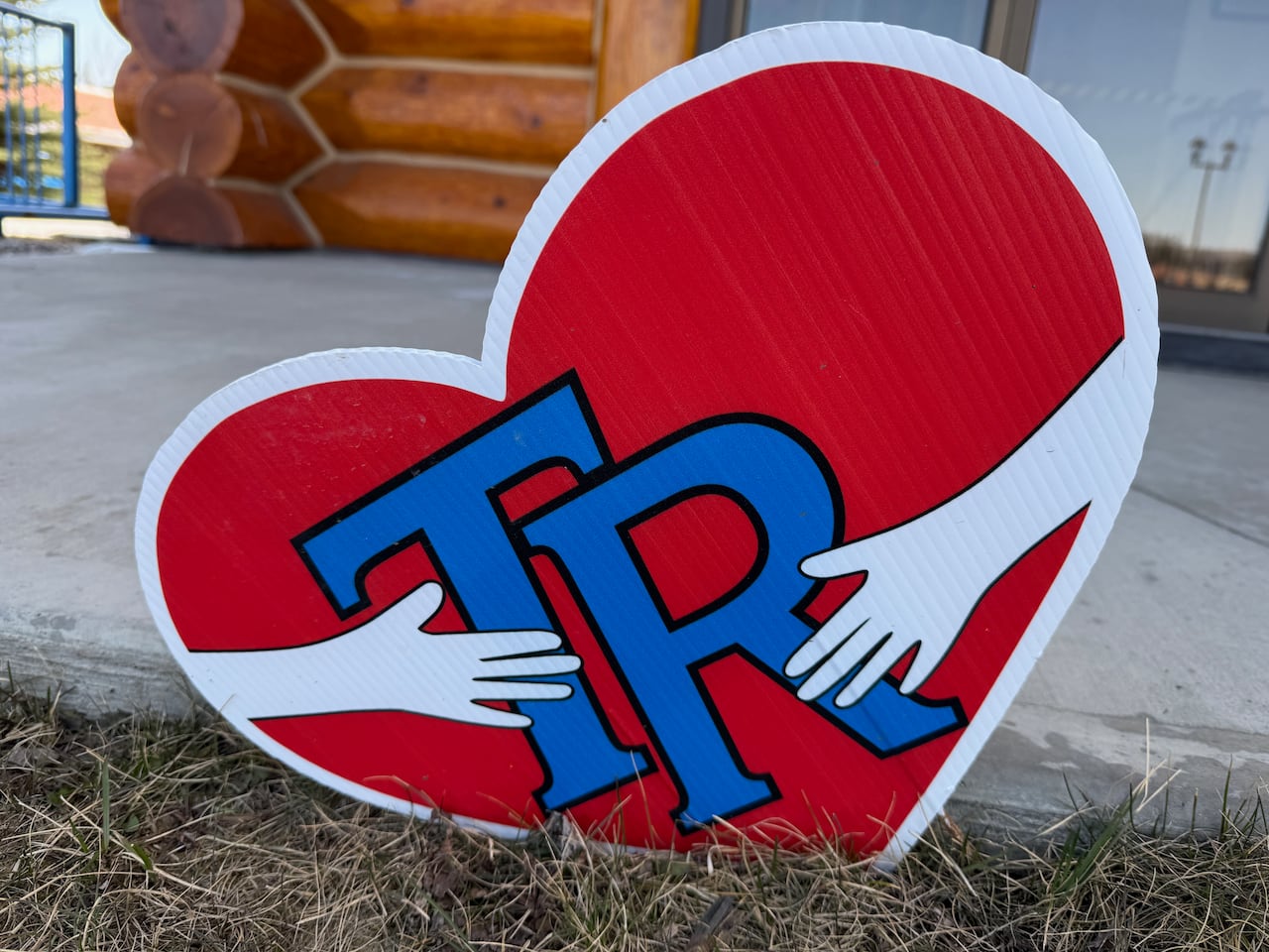 A heart with supporting hands on each side, one of many pieces of art created in support of the victims of the Feb. 10, 2026 mass shooting in Tumbler Ridge.