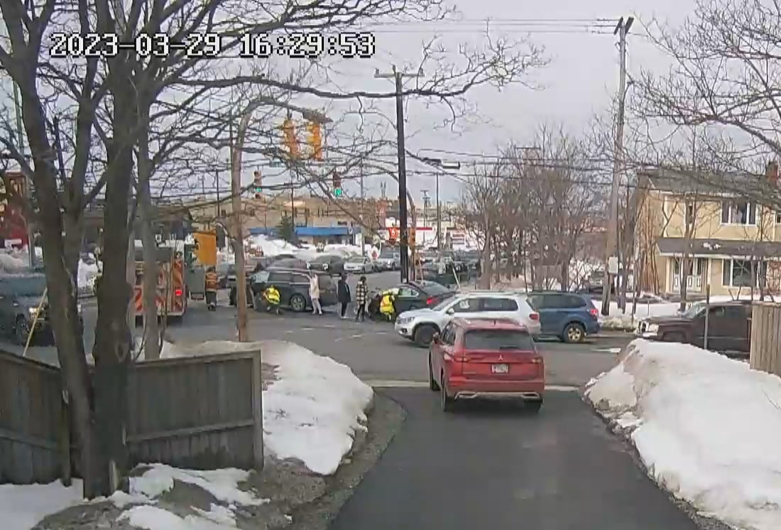 A still from a surveillance camera shows a cluster of vehicles and first responders.