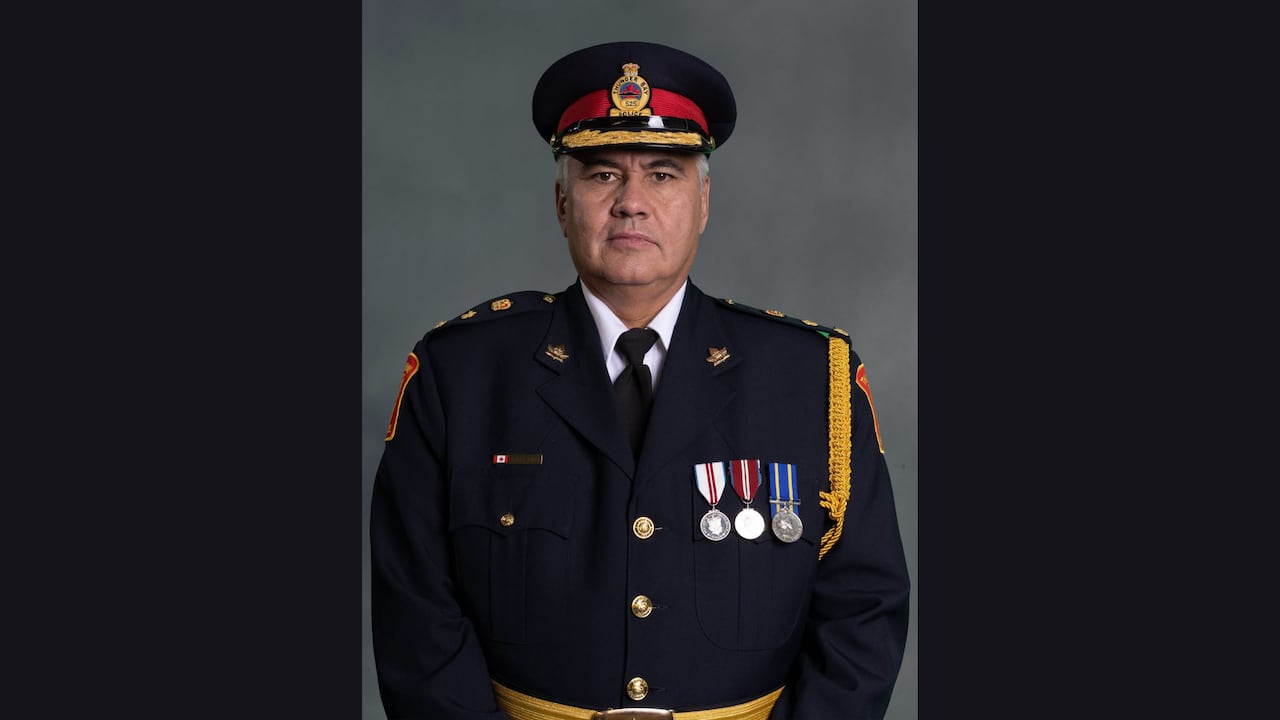 A person is seen in a police uniform.