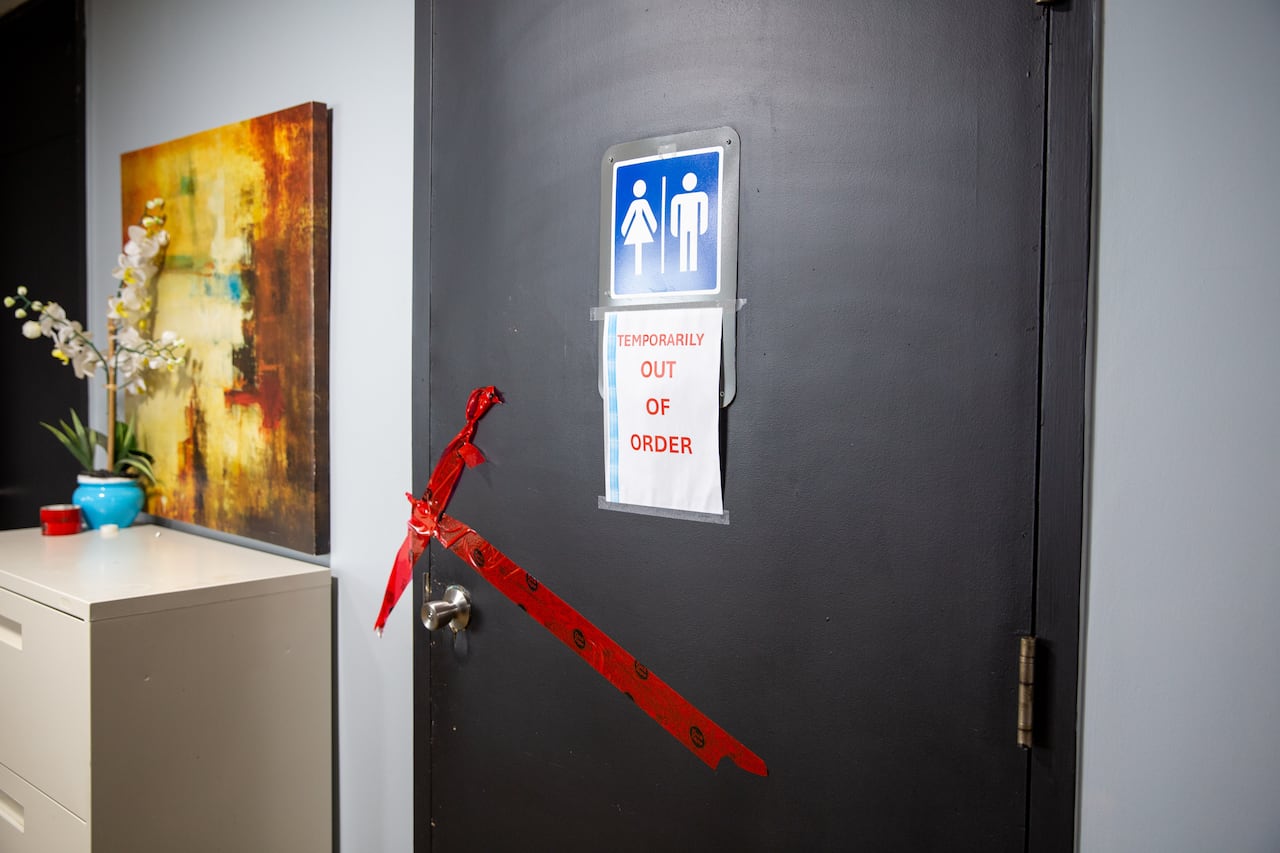 A sign on a washroom door that says 'temporarily out of order.'