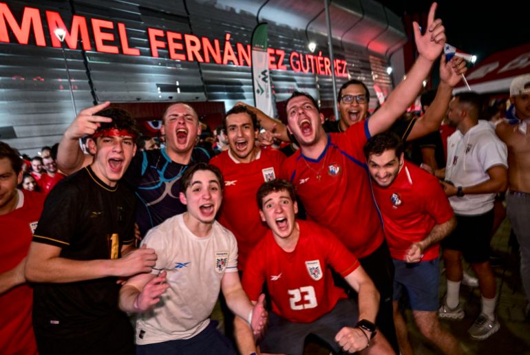Panamanians pose for pictures as they celebrate after Panama qualified for the 2026 FIFA World Cup in Panama City on November 18, 2025. (Photo by MARTIN BERNETTI / AFP)