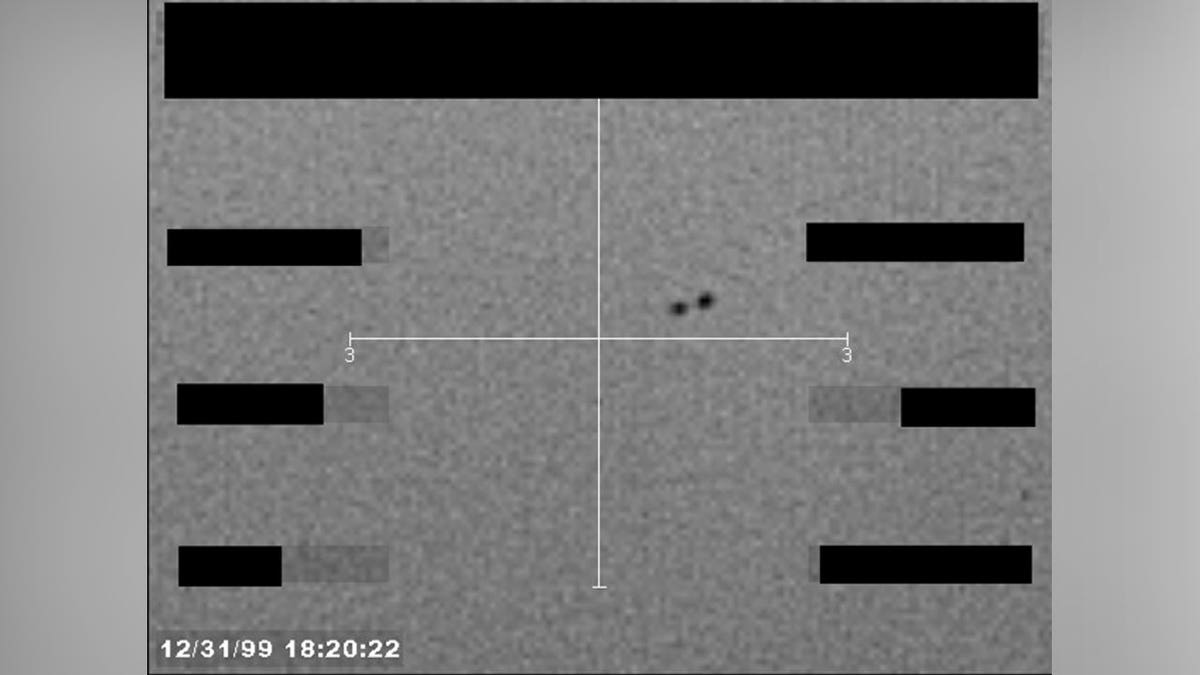 An FBI photo containing two black dots that appear to be UAPs