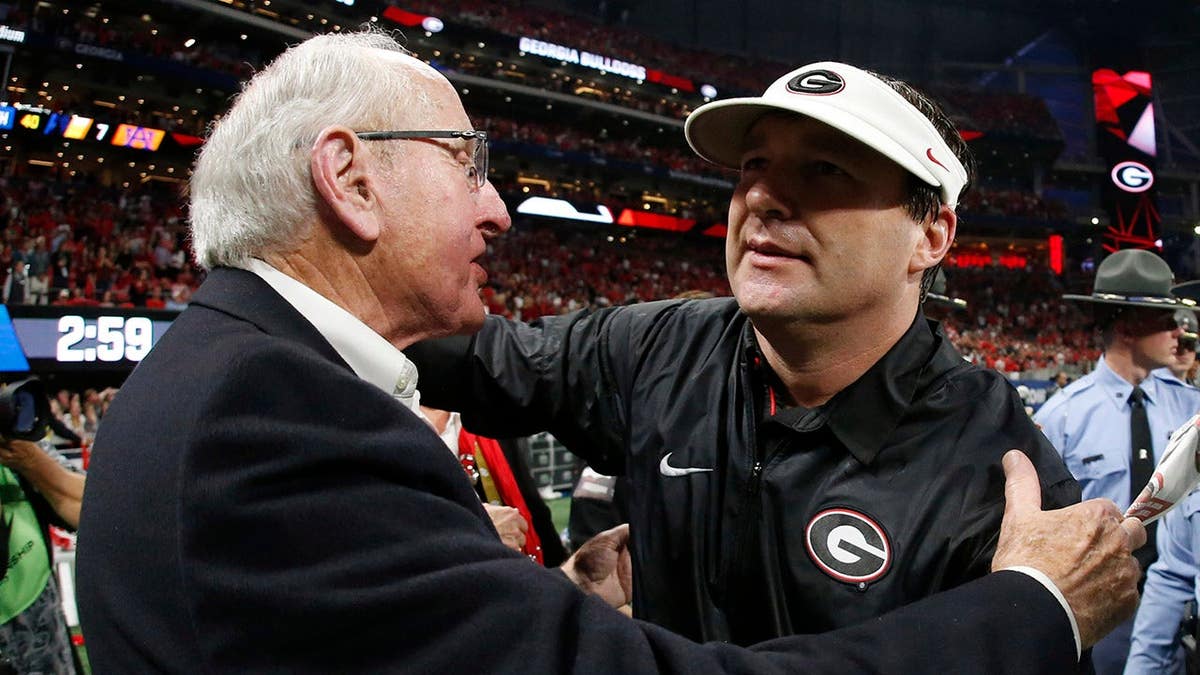 Georgia coach Kirby Smart embraces Vince Dooley at Mercedes-Benz Stadium.
