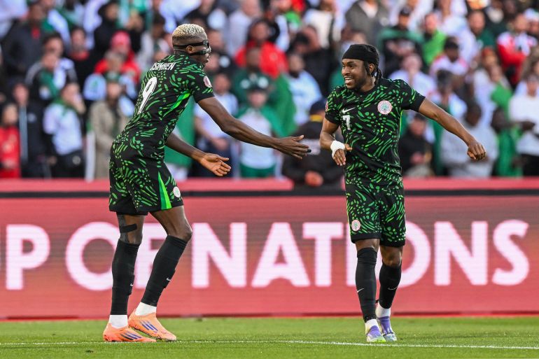 Nigeria's forward #09 Victor Osimhen celebrates his goal with Nigeria's forward #07 Ademola Lookman during the Africa Cup of Nations (CAN) quarter-final football match between Algeria and Nigeria at the Grand stadium in Marrakesh on January 10, 2026.
