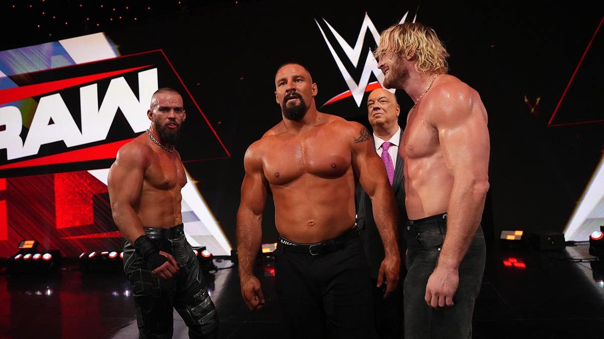Austin Theory and Logan Paul standing with Bron Breakker and Paul Heyman at Greensboro Coliseum Complex