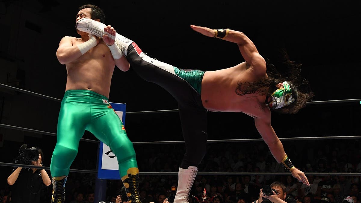 Bandido and Ryusuke Taguchi wrestling in a ring at Korakuen Hall in Tokyo