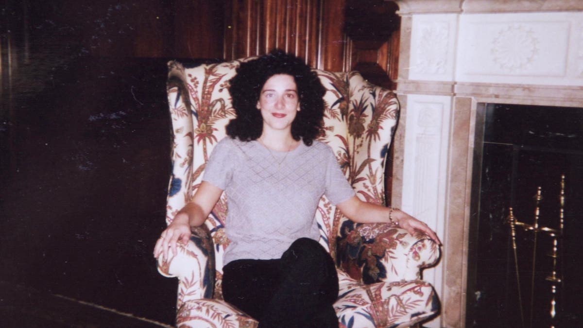 Chandra Levy sitting indoors beside a fireplace in an undated family photo