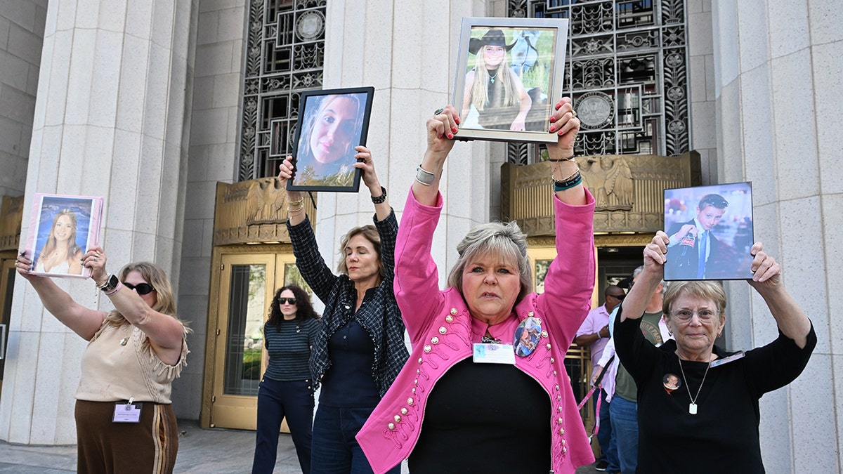 Lori Schott holding a photo of her daughter Annalee Schott outside Los Angeles Superior Court