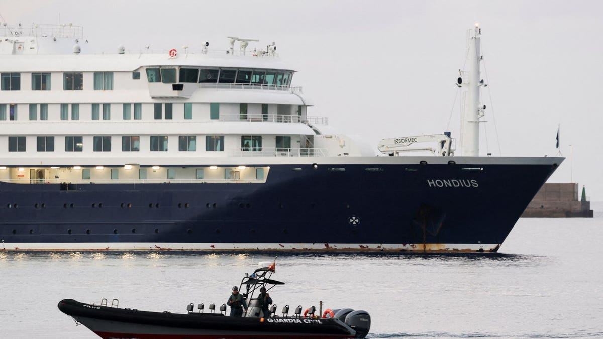 A police boat operates next to the cruise ship MV Hondius at the port of Granadilla de Abona