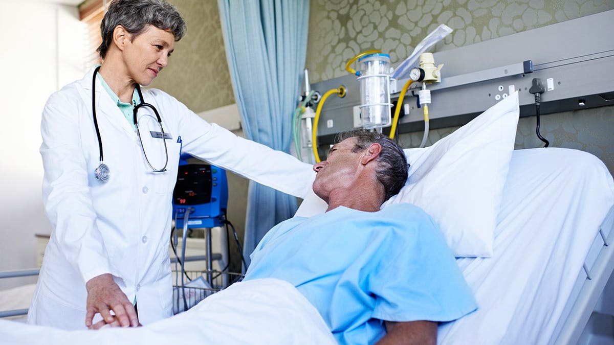 Doctor talking to a patient in a hospital ward