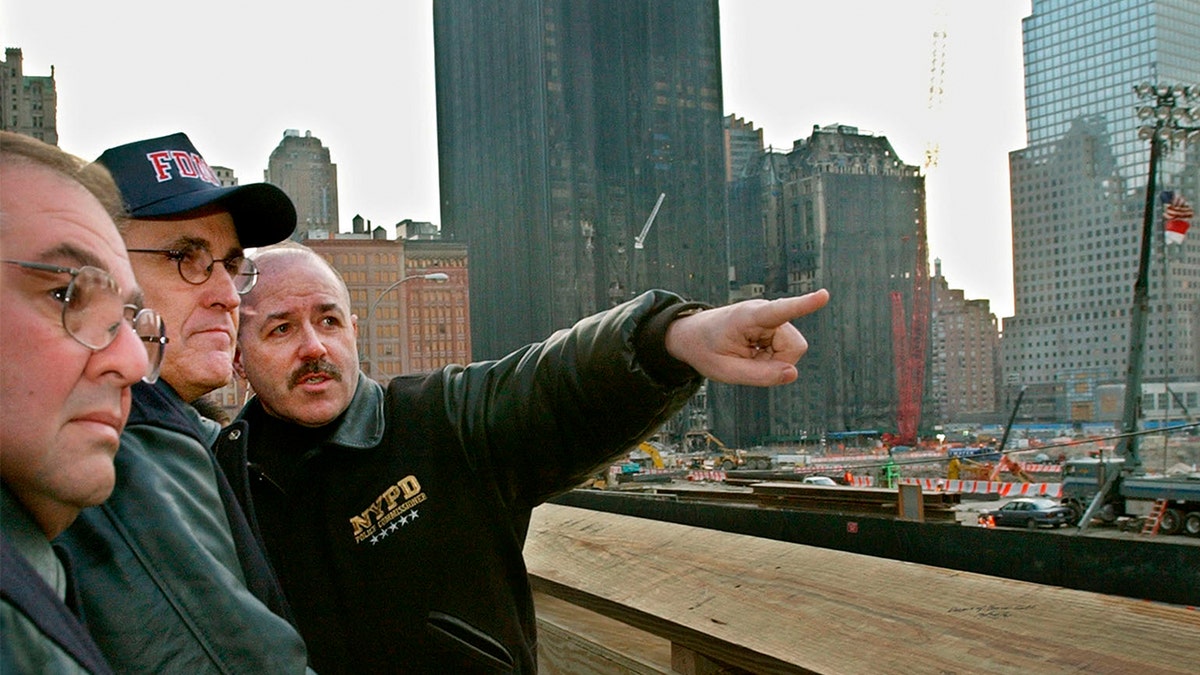 New York Mayor Rudy Giuliani standing with Police Commissioner Bernard Kerik and Emergency Management Director Richard Scheirer