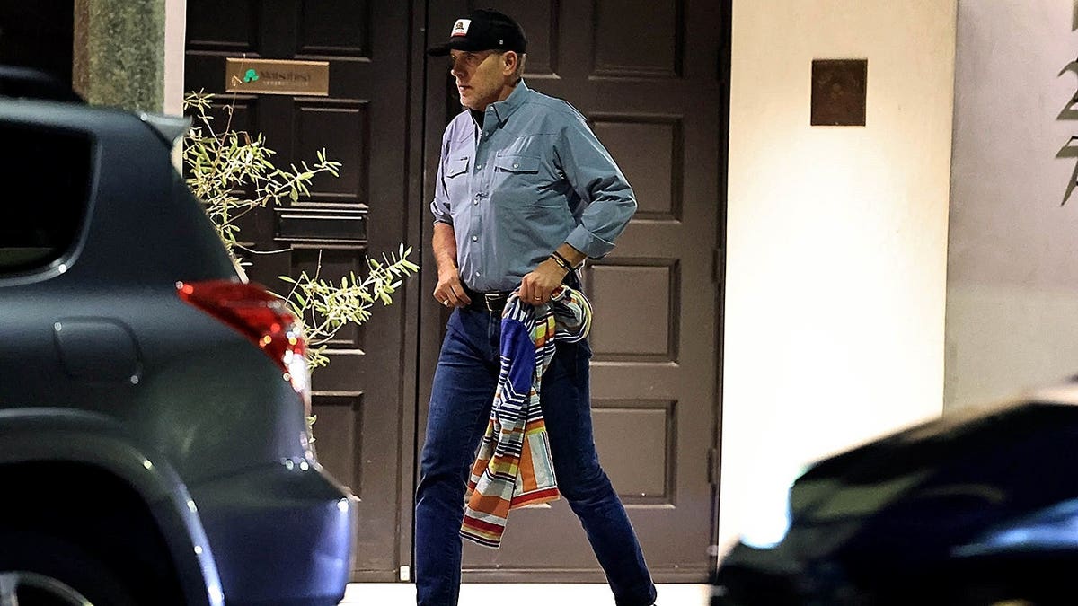 Hunter Biden tucking his shirt in after leaving a restaurant in Los Angeles
