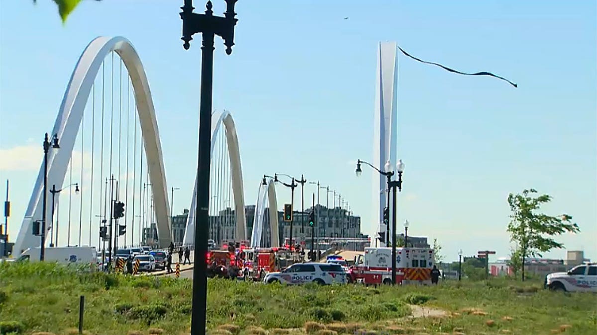 Emergency personnel next to a bridge