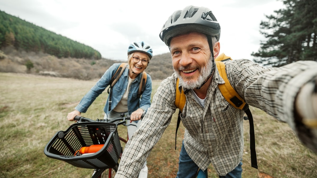 Older couple healthy and riding bikes