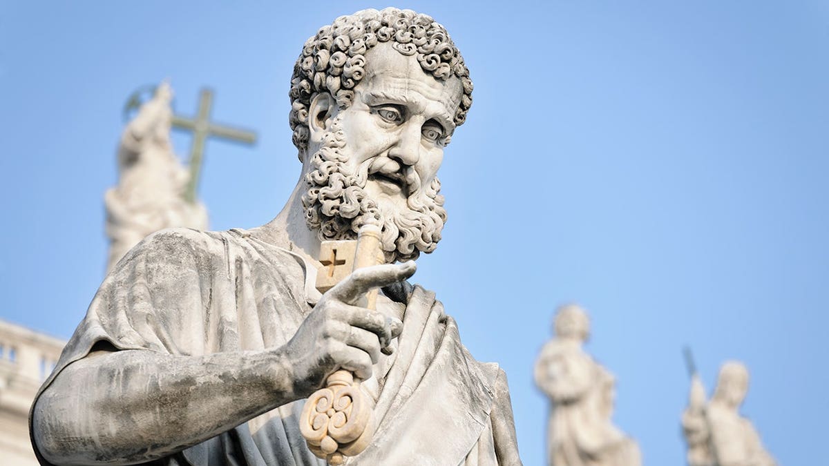 Close-up of Saint Peter statue holding a gold key in Vatican City
