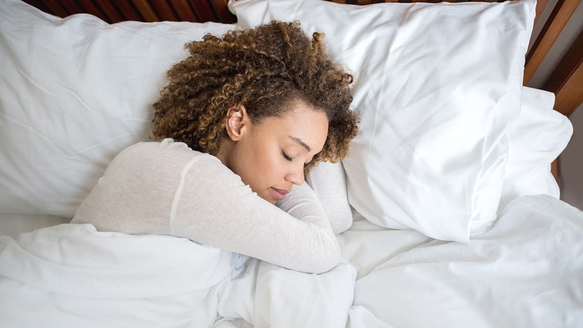 Tired woman sleeping in bed at home