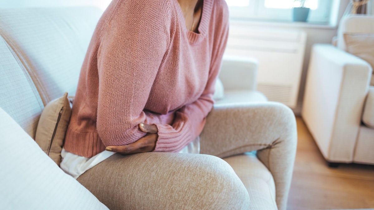 Woman holding stomach in pain