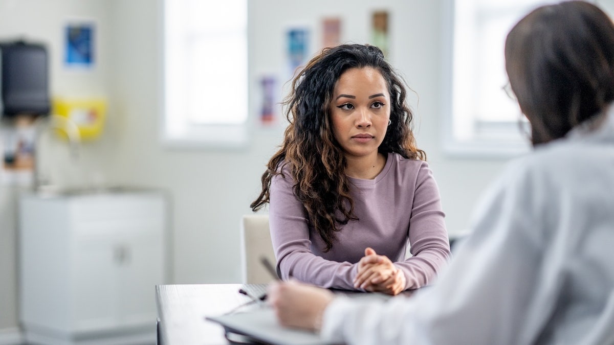 A young woman sitting with her female doctor during a mental health discussion