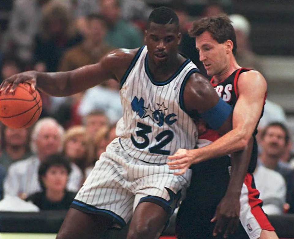 ORLANDO, UNITED STATES: Orlando Magic center Shaquille O'Neal (L) drives into Portland Trailblazers center Chris Dudley during first period action 10 March at the Arena in Orlando, Fl. (COLOR KEY: Ball is orange.) AFP PHOTO (Photo credit should read TONY RANZE/AFP via Getty Images)