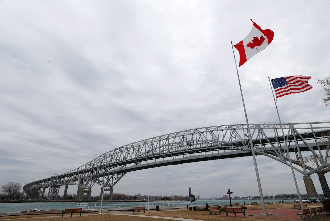 Vehicles move across the Blue Water Bridge in Port Huron, Mich., to Sarnia, Ontario, Canada, Wednesday, March 18, 2020.