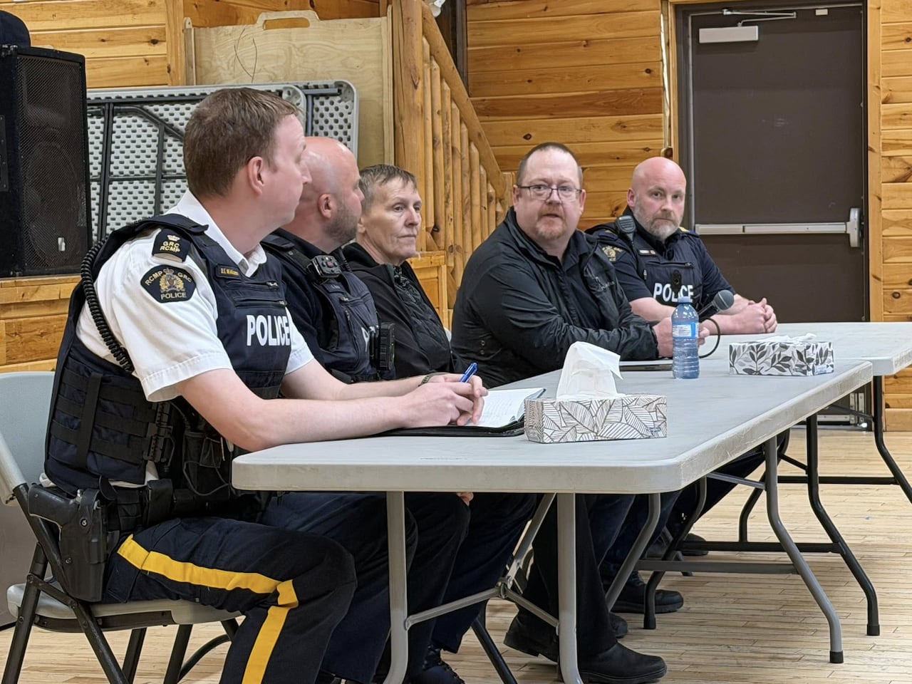 Several people sitting down at a meeting.