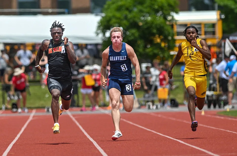 Big Walnut’s Jamier Brown, left, runs alongside Granville’s Bode Shoaps and Beechcroft’s Nehemiah Mills in the 100 meters during the Division II state meet June 7. Brown won the event, helping Big Walnut tie for the team championship.