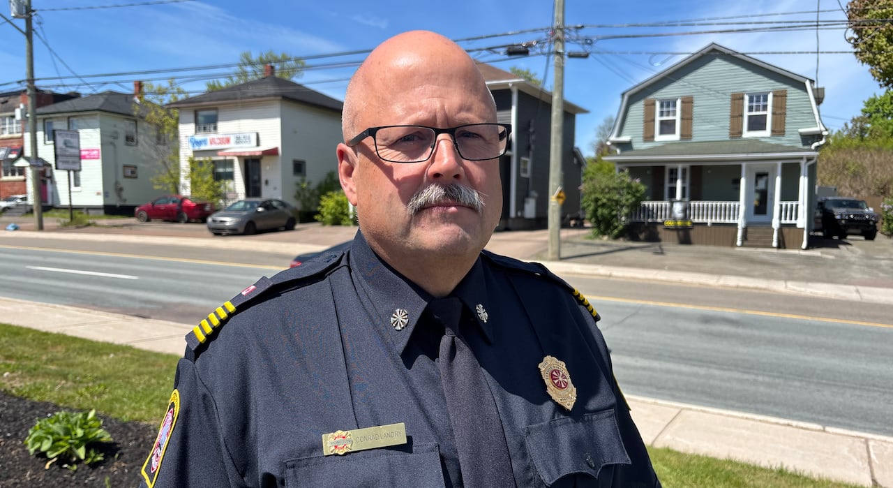 A man in a Moncton Fire uniform standing outside.