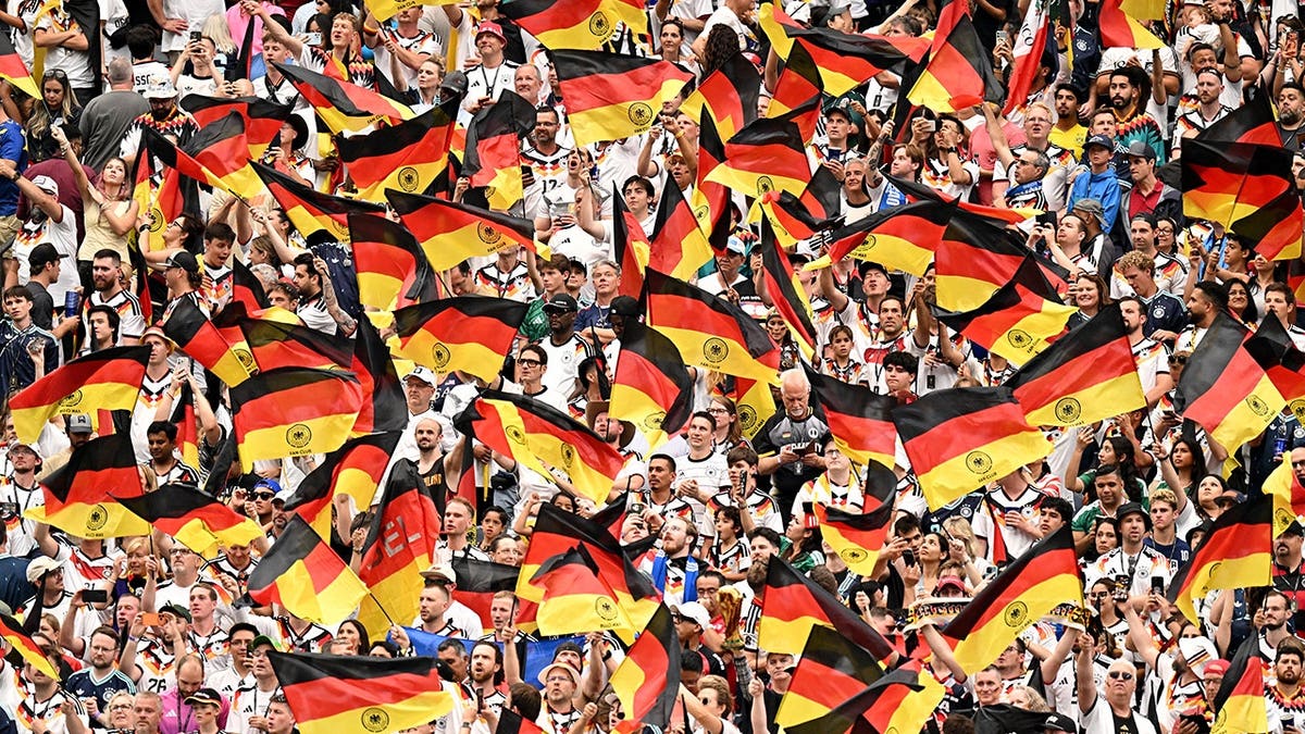 Germany fans seated in the stands at a sports event.